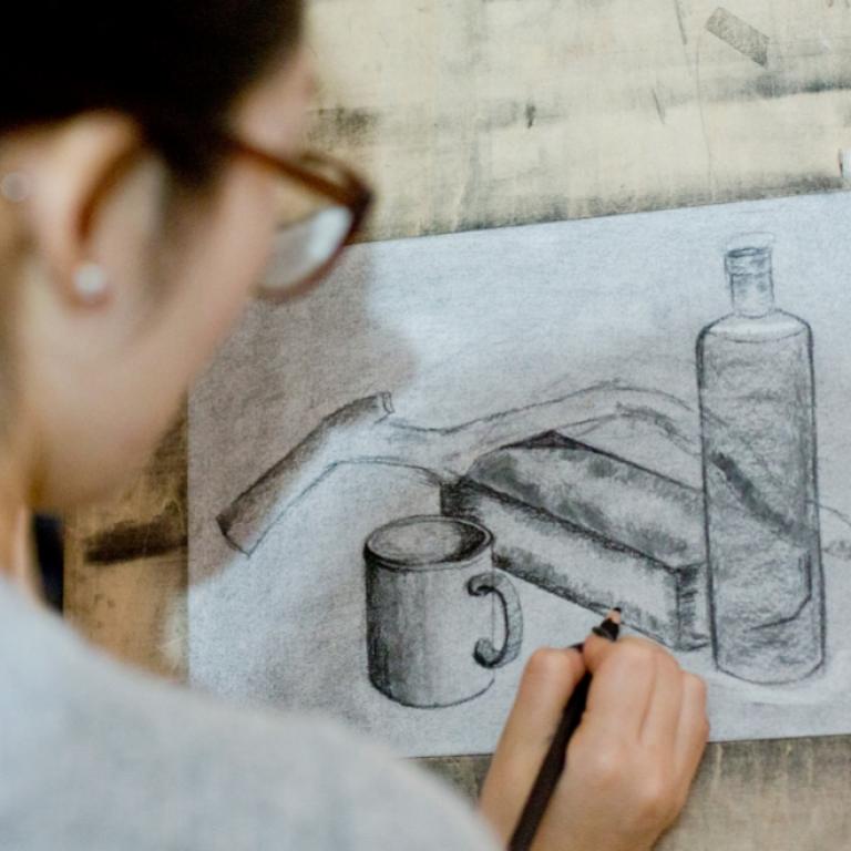 Girl sketching a still life