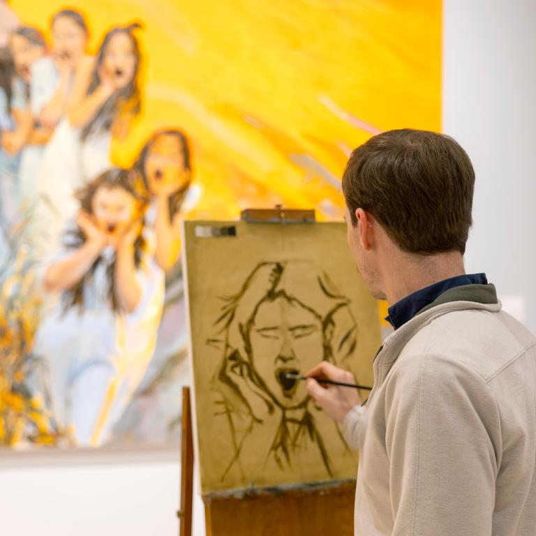 artist drawing at an easel
