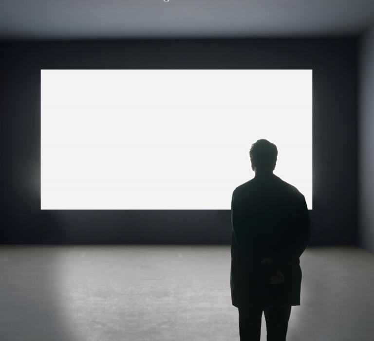 Alfredo Jaar facing "Lament of the Images," 2002. Courtesy of the artist.
