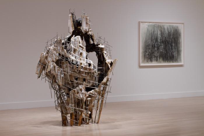 Diana Al-Hadid, left to right: "Tomorrow's Superstitions," steel, polystyrene, polymer gypsum, silver leaf and paint, 85" x 60" x 48", 2008. Collection of Dr. Robert Feldman, Winter Park, Florida; and "Untitled," charcoal, watercolor, Conté and pastel on Mylar, 41 1/2" x 54 1/2", 2011. Private collection. Courtesy of Miyoshi Art Projects, Santa Monica, California. Installation view: Weatherspoon Art Museum/UNCG, 2013. Photograph by C. Timothy Barkley.