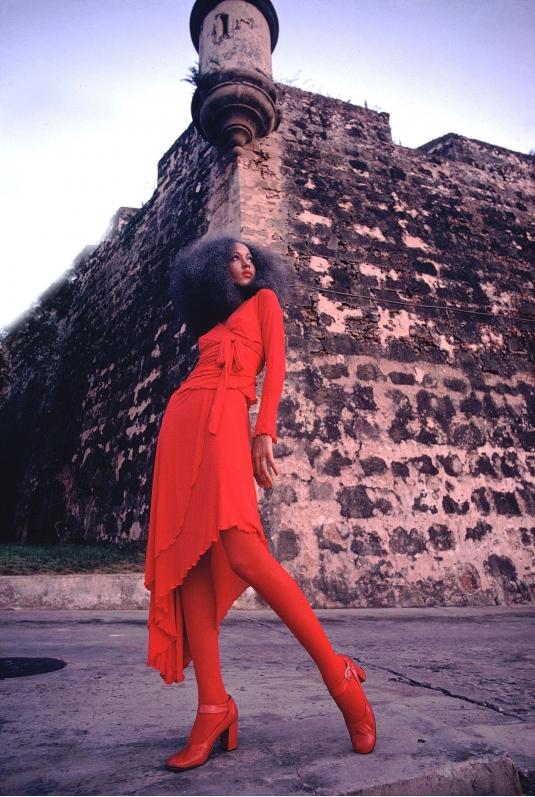 Pat Cleveland in red two-piece matte jersey skirt with wrap top and matching red stockings and shoes. Selected by Diana Vreeland. San Juan, Puerto Rico, 1972. Photograph courtesy of Charles Tracy.