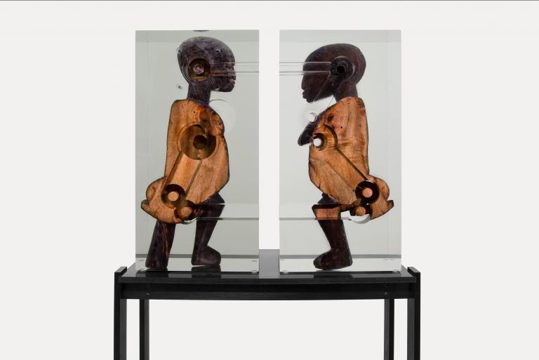 Matthew Angelo Harrison, "Dark Silhouette: Couple Transfigured," 2018, West African wooden sculpture, polyurethane resin, anodized aluminum, and acrylic, 63 1/2 x 53 5/8 x 17 1/2 in. Photo by Tim Johnson. Courtesy of Rennie Collection, Vancouver. Signature image for Matthew Angelo Harrison exhibition